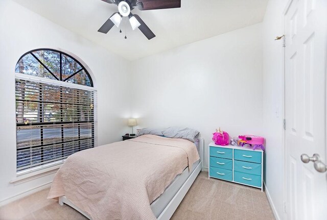 bedroom featuring ceiling fan and light colored carpet