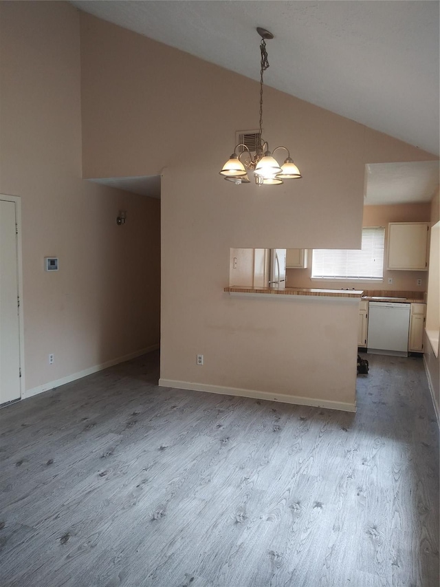 interior space with hardwood / wood-style floors, vaulted ceiling, and a notable chandelier