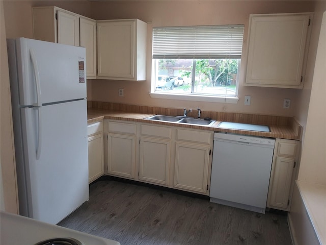 kitchen with sink, white cabinets, dark hardwood / wood-style floors, and white appliances