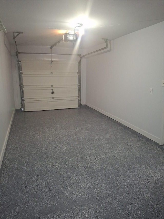 garage featuring baseboards and a garage door opener