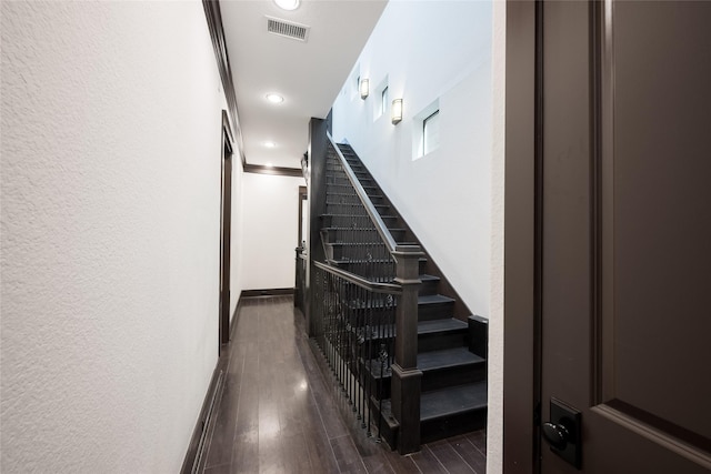 stairs featuring hardwood / wood-style floors