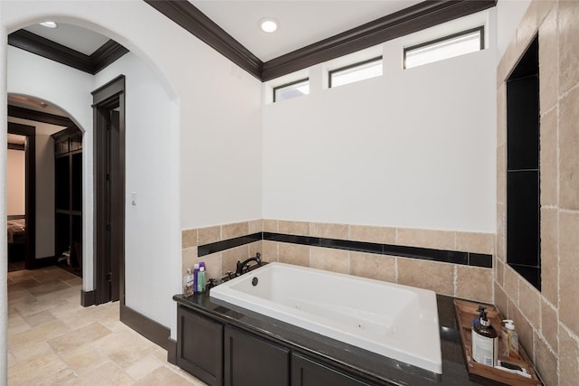 bathroom featuring a tub to relax in and ornamental molding