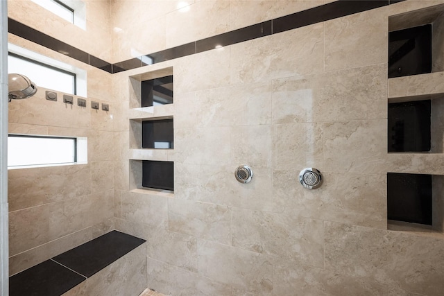 bathroom with tiled shower