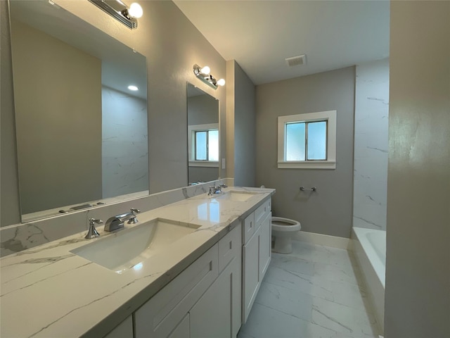 bathroom with vanity, toilet, and a bathing tub