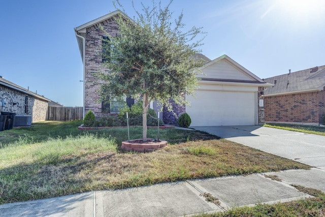 view of front of home featuring cooling unit, a garage, and a front yard