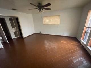 unfurnished room featuring dark hardwood / wood-style floors and ceiling fan