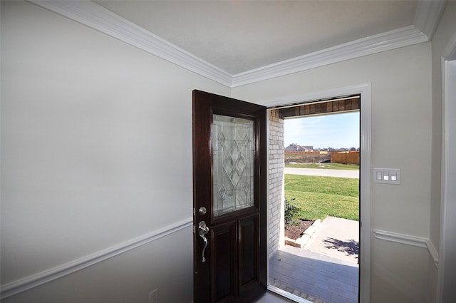 foyer entrance featuring crown molding