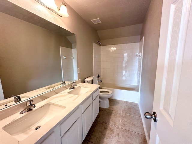 full bathroom with toilet, vanity, tile patterned flooring, and tiled shower / bath