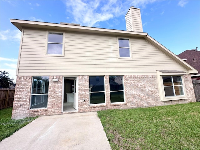 back of house with a yard and a patio