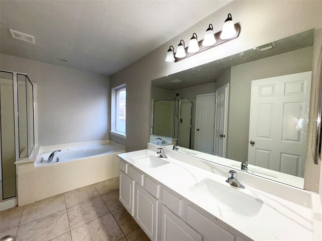 bathroom with a textured ceiling, plus walk in shower, tile patterned floors, and vanity