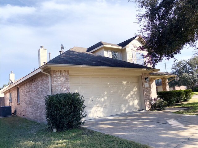 view of property exterior featuring central AC unit and a garage