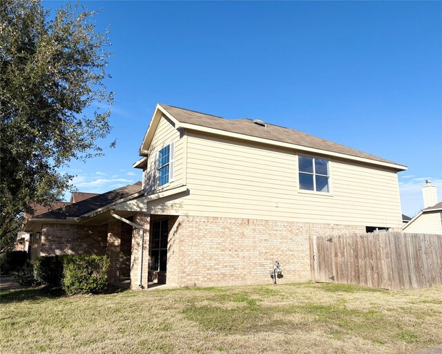 view of side of home featuring a lawn