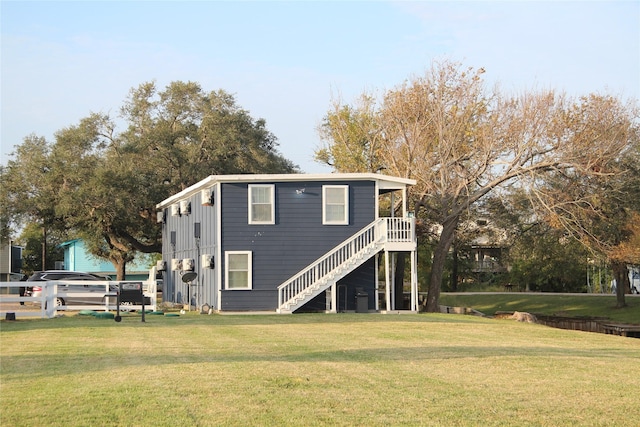 back of house featuring a yard