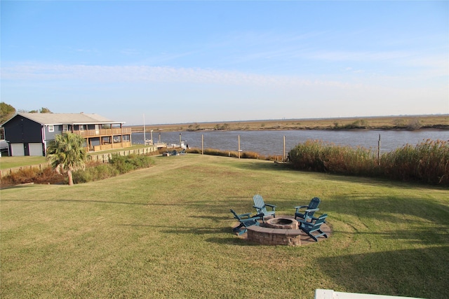 view of yard with a water view and an outdoor fire pit