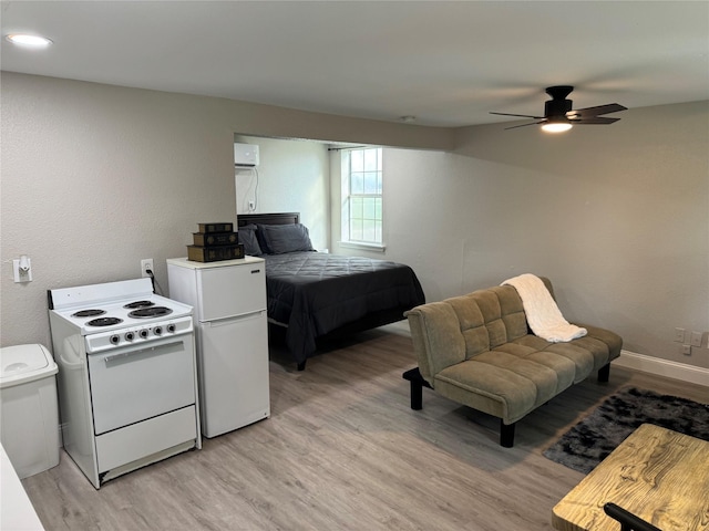 bedroom featuring ceiling fan, light hardwood / wood-style floors, and fridge