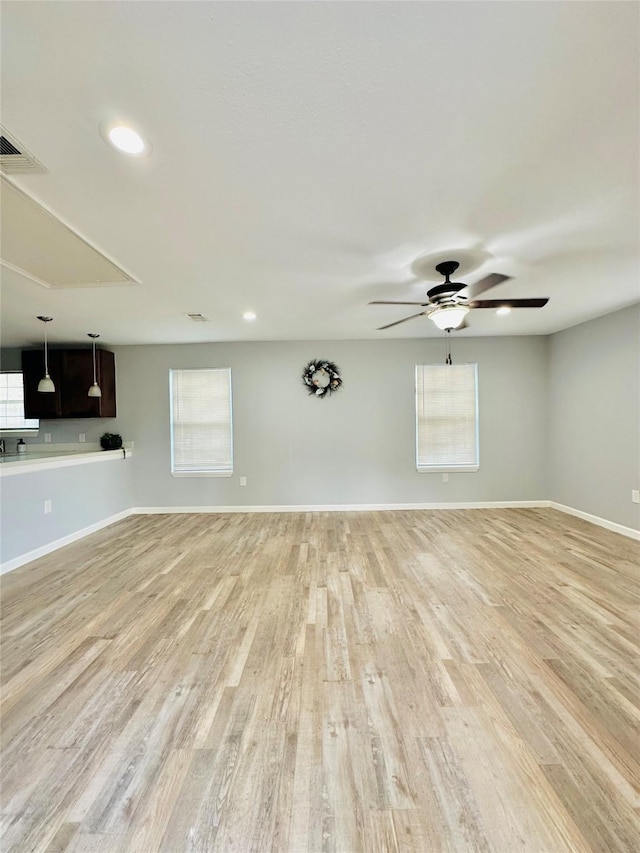 unfurnished room with ceiling fan, light hardwood / wood-style flooring, and plenty of natural light