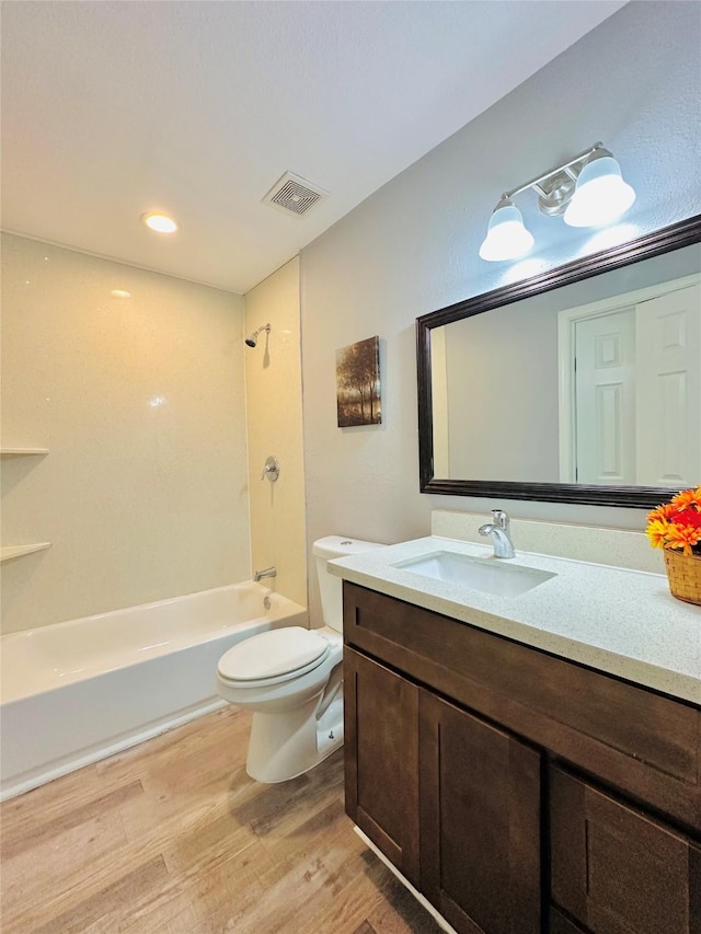 full bathroom with toilet, vanity, hardwood / wood-style flooring, and shower / bath combination