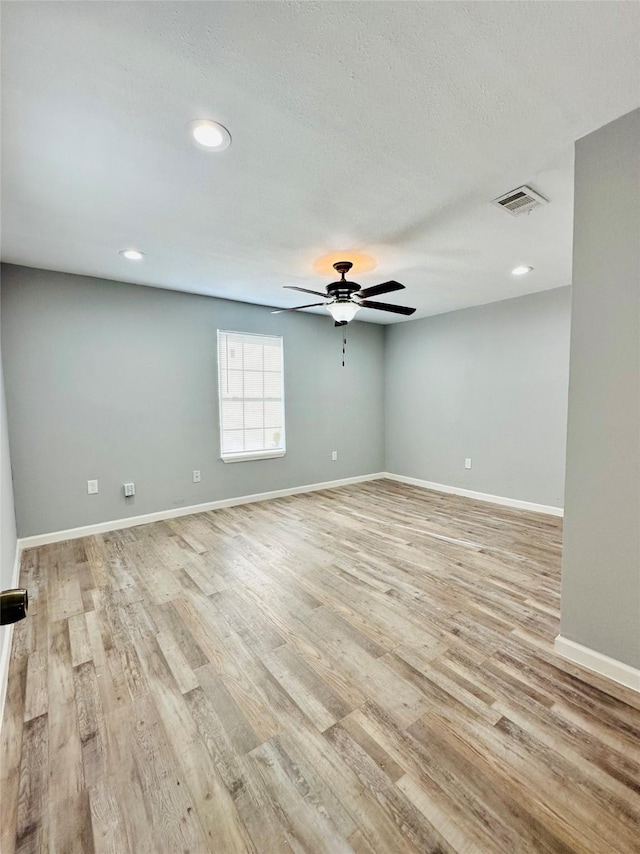 unfurnished room featuring ceiling fan and light hardwood / wood-style floors