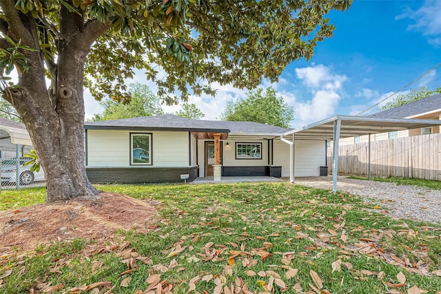 view of front facade with a front lawn and a carport