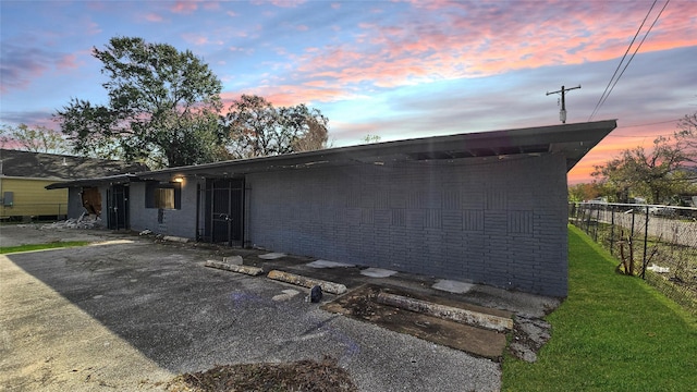 property exterior at dusk with a patio