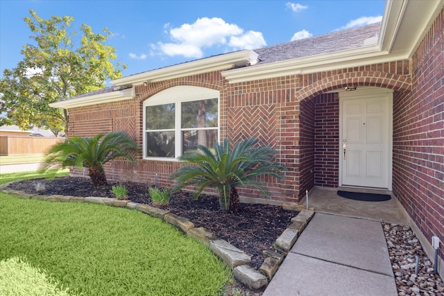 entrance to property featuring a yard