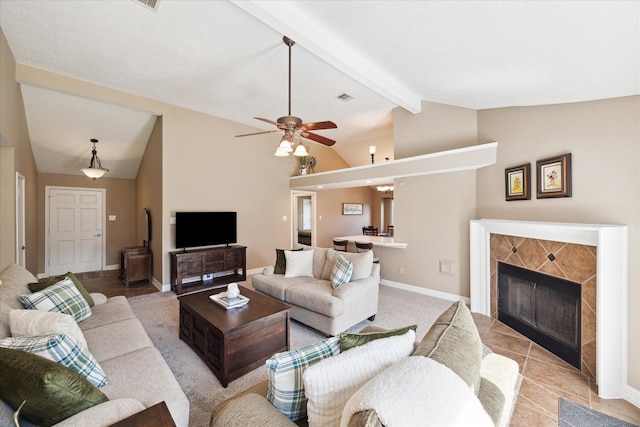 living room featuring ceiling fan, a fireplace, and lofted ceiling with beams