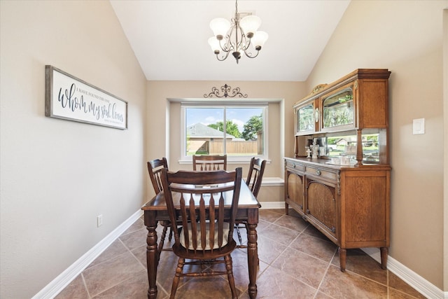 tiled dining room with an inviting chandelier and vaulted ceiling