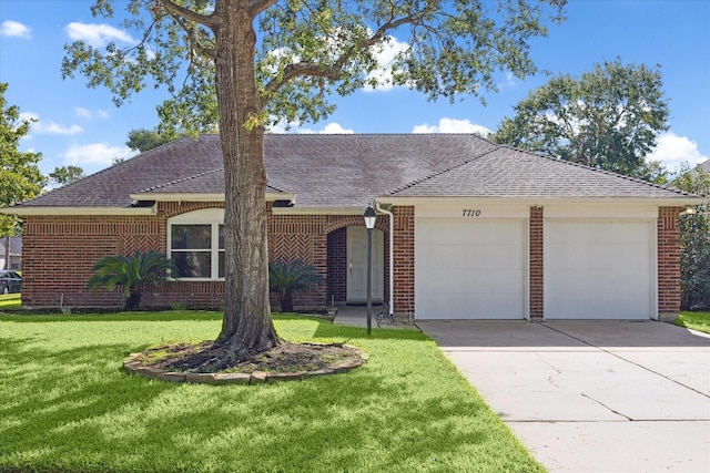 single story home with a garage and a front yard