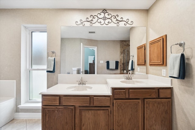 bathroom with tile patterned floors, vanity, and independent shower and bath