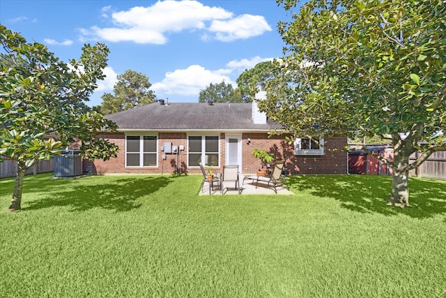 back of house with central AC unit, a patio area, and a lawn