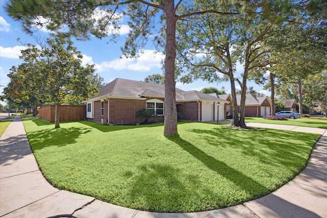 view of front of home with a front yard and a garage