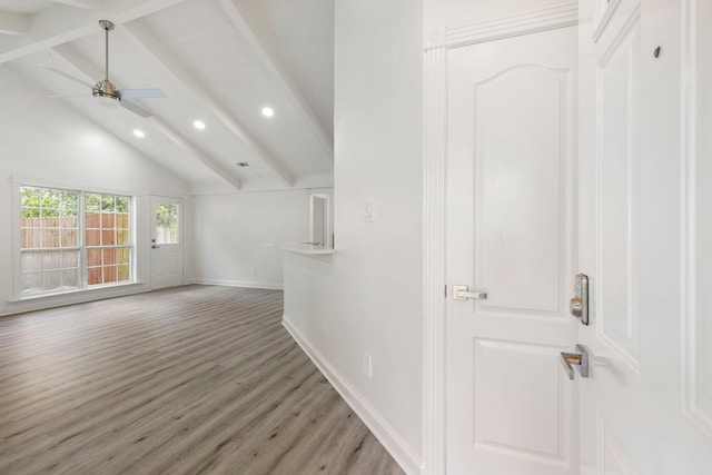 unfurnished living room with vaulted ceiling with beams, ceiling fan, and hardwood / wood-style floors