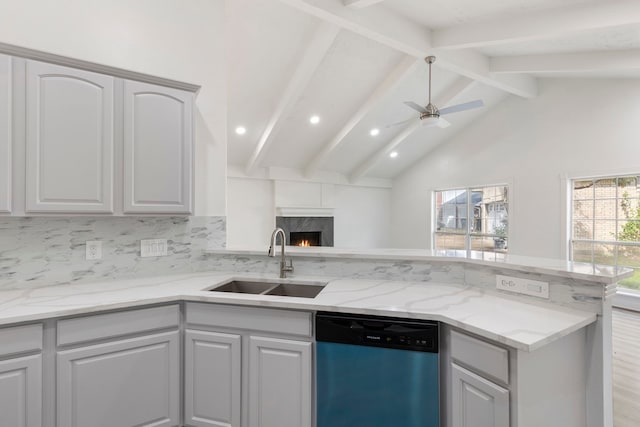 kitchen with ceiling fan, sink, a high end fireplace, stainless steel dishwasher, and decorative backsplash