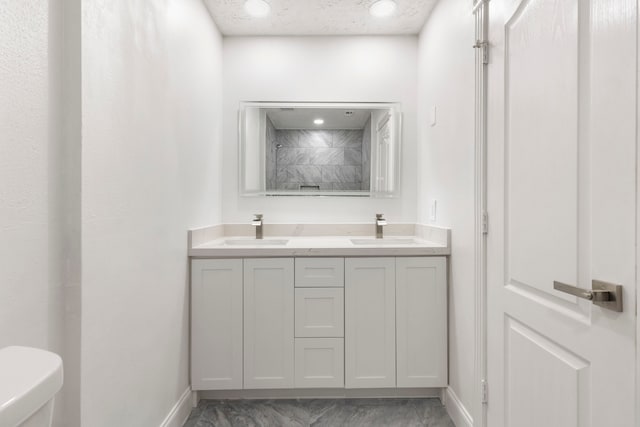 bathroom featuring vanity, toilet, and a shower