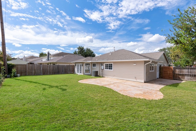 back of property featuring a lawn, a patio, and central AC unit