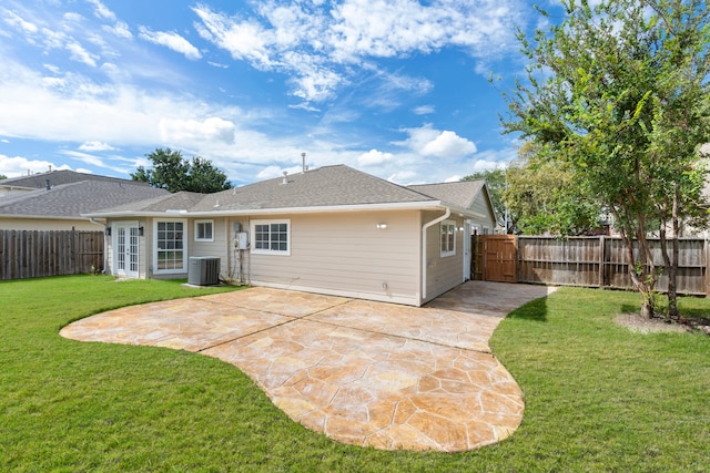 back of house with a patio area, a yard, and central AC