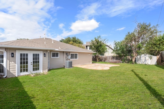 view of yard with central air condition unit, a patio, and a shed