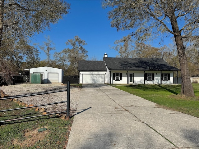 ranch-style house with a garage, an outdoor structure, and a front lawn