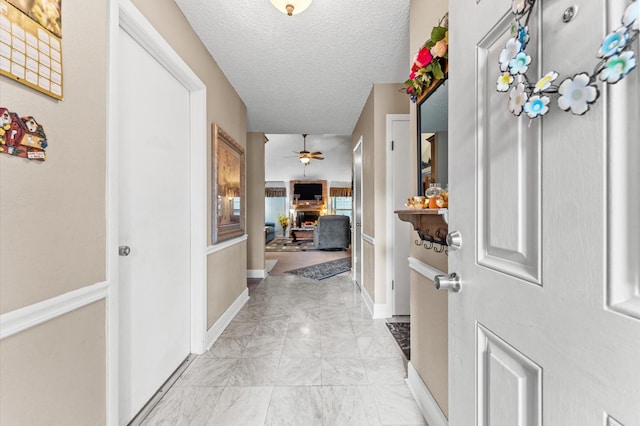 hallway featuring a textured ceiling