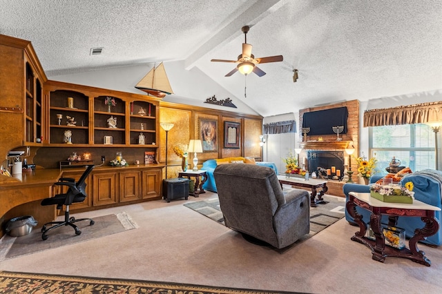 living room with a textured ceiling, light colored carpet, ceiling fan, lofted ceiling with beams, and a fireplace