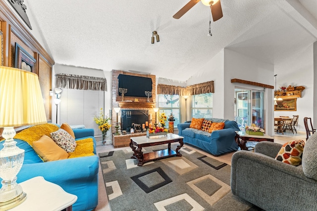 living room with a textured ceiling, high vaulted ceiling, and ceiling fan