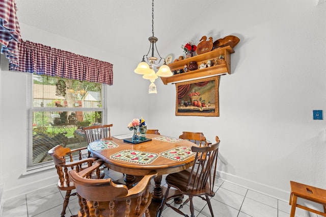 tiled dining space with an inviting chandelier