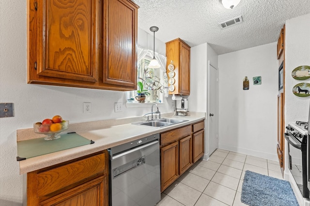 kitchen featuring dishwasher, sink, pendant lighting, light tile patterned floors, and white stove