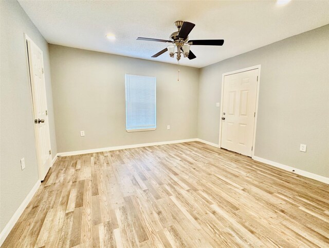 unfurnished room with ceiling fan and light hardwood / wood-style floors