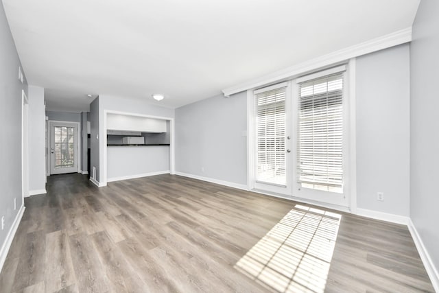 unfurnished living room featuring hardwood / wood-style flooring