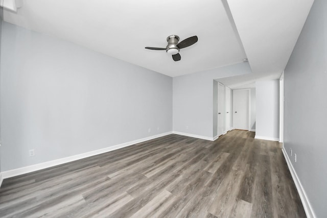 spare room with ceiling fan and dark wood-type flooring