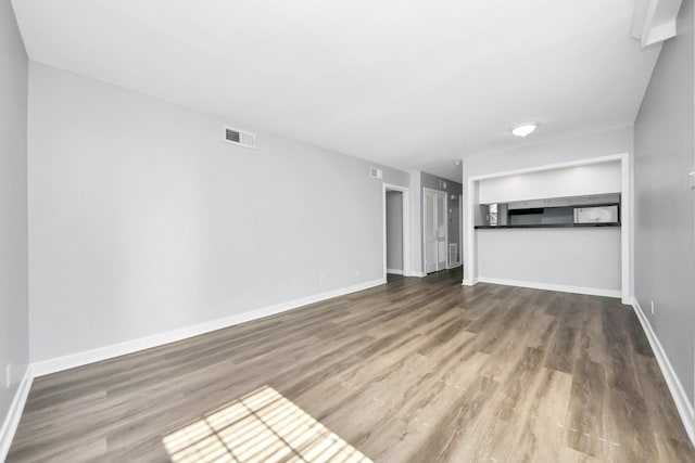 unfurnished living room with wood-type flooring