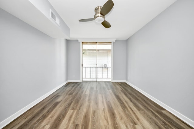 spare room featuring ceiling fan and dark hardwood / wood-style floors