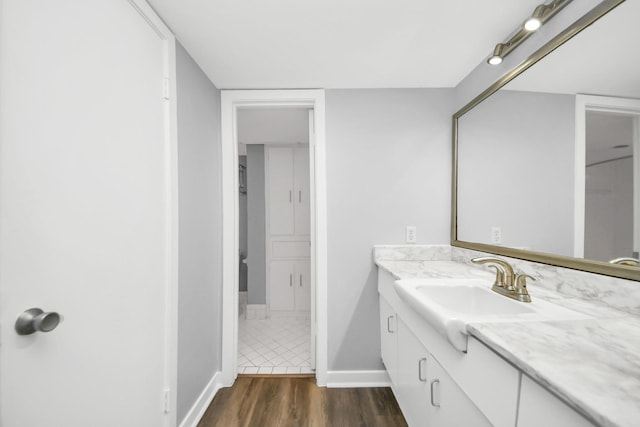 bathroom with hardwood / wood-style floors and vanity