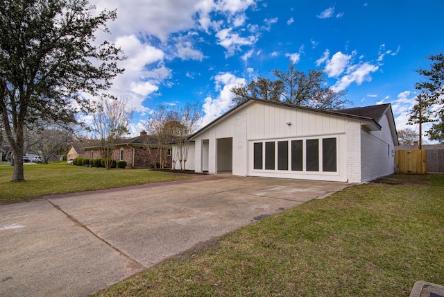 exterior space with a garage and a lawn